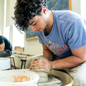 A student in pottery class. Links to Closely Held Business Stock