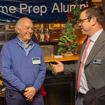 Two alumni talking at a reunion event. Links to Gifts of Appreciated Securities
